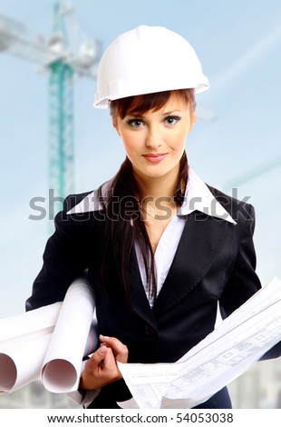 Smiling young female architect holding blueprints isolated on white background