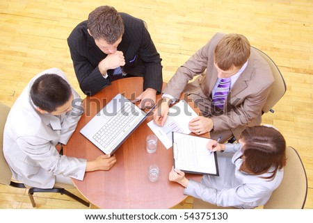 Top view of business people sitting in the meeting