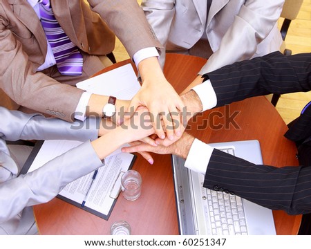 businessteam and hands on top of each other