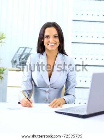 Young happy smiling businesswoman working at office