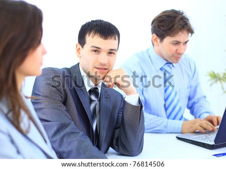 Portrait of successful businessman and business team at office