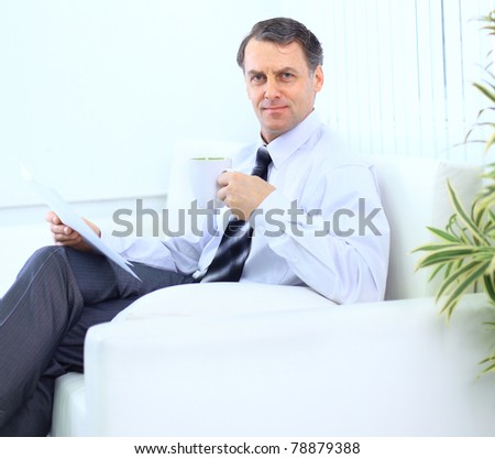entrepreneur working from home looking very relaxed in his sofa browsing the web in his laptop computer