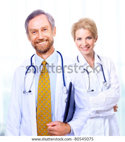 A medical team of doctors, man and woman, isolated on white background