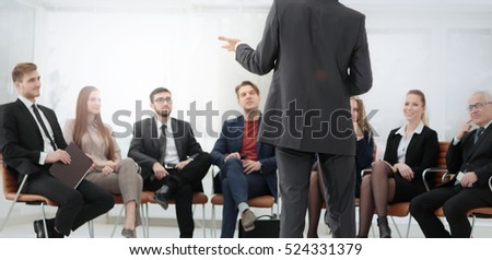 Member of the business team asks a question to the speaker at a