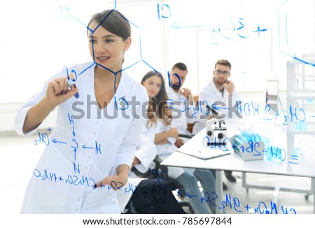 view through the transparent Board. female scientist makes a report to colleagues
