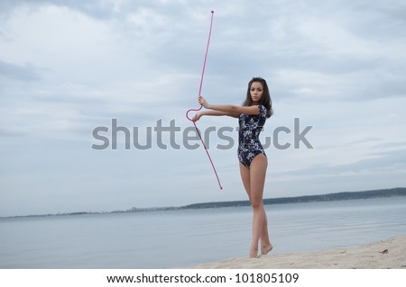 young professional gymnast woman dance with skipping rope - outdoor sand beach