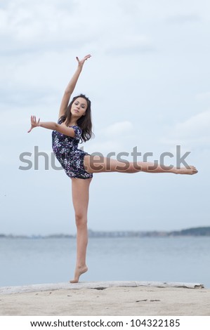 young professional gymnast woman dance - outdoor sand beach