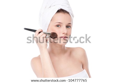 Close-up portrait of young beautiful woman with brush for make-up. Cheek zone