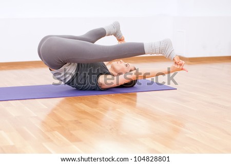 Beautiful sport woman doing stretching fitness exercise at sport gym. Yoga