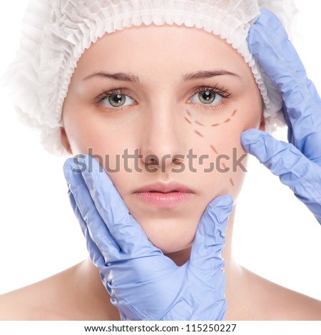 Beautician touch and draw correction lines on woman face. Before plastic surgery operetion. Isolated on white
