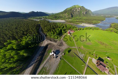Beautiful small green village with river from above (aerial view)