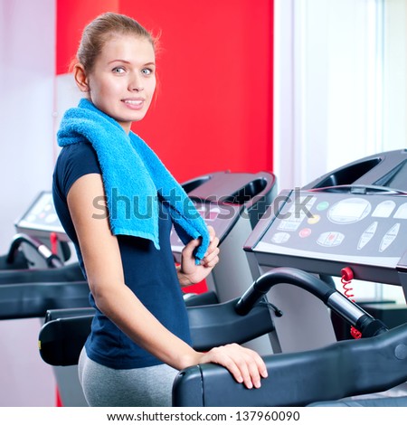 Young woman at the gym exercising. Run on machine