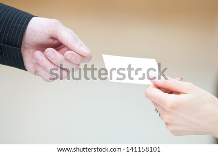 Concept shot of exchange business card between man and  woman. Partnership