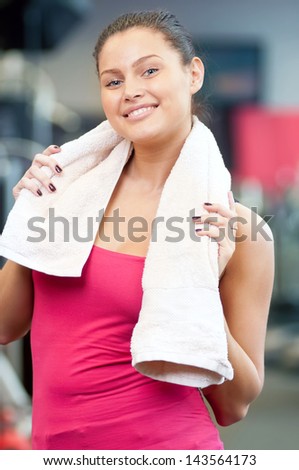 Young woman drinking water after sports. Fitness gym.