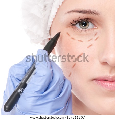 Beautician touch and draw correction lines on woman face Before plastic surgery operetion Isolated on white Beautician touch and draw correction lines on woman face Before plastic surgery operetion Isolated on white