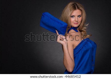 Closeup portrait of beautiful fashion woman in blue suit and blue bag