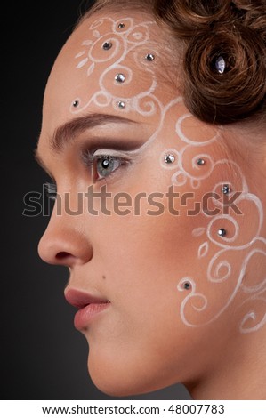 Close up portrait of beautiful girl with curly hair style, spiral face and body art and stars