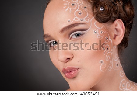 Close up portrait of beautiful girl with curly hair style, spiral face and body art and stars