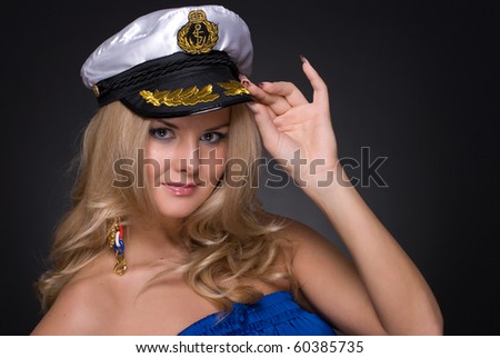 Closeup portrait of beautiful fashion woman in blue suit and sailor cap