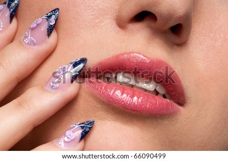 Close-up face of beauty young woman - lips makeup zone and nail art