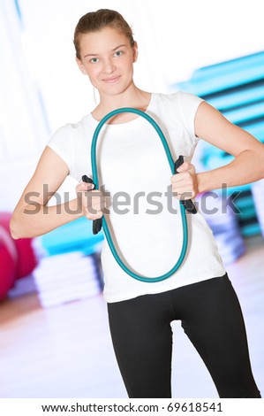 Beautiful sport woman doing power fitness exercise at sport gym. Expander