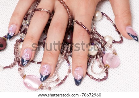 Closeup hands nail art zone. Pink and blue with jewel. High resolution.