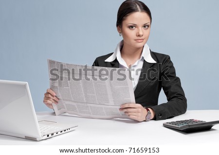 Busy business woman with frash newspaper over white table and laptop. Sure