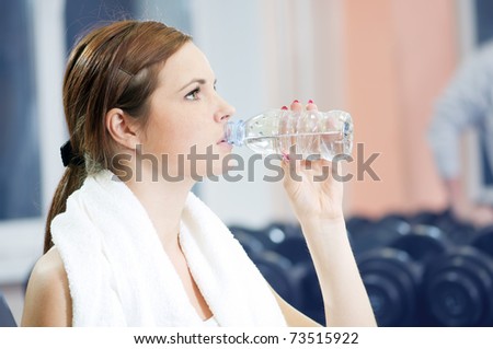 Beautiful sport woman drink water after after fitness exercise at sport gym