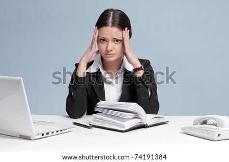 Sad business woman in office working with white table, laptop and diary personal organizer. Crisis!