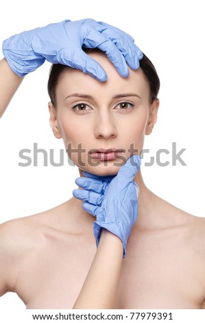 Beautician touch and exam health woman face. Plastic surgery. Isolated