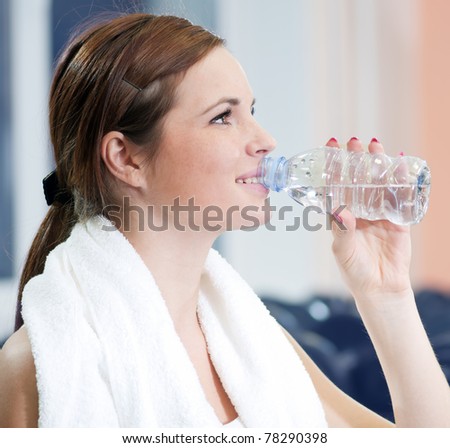 Beautiful sport woman drink water after after fitness exercise at sport gym