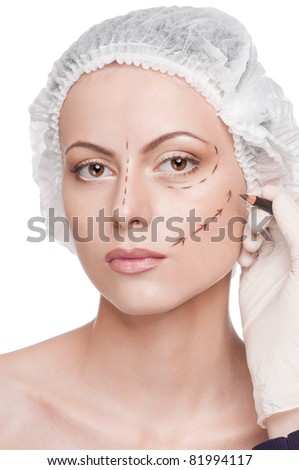 Beautician touch and draw correction lines on woman face. Before plastic surgery operetion. Isolated