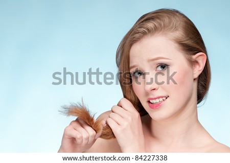 Close up portrait of young displeasure woman that comb perfect hair