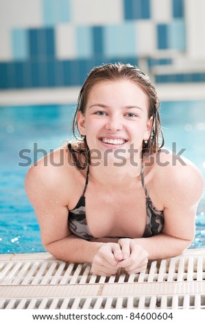 Portrait of a young beauty woman in swimming pool
