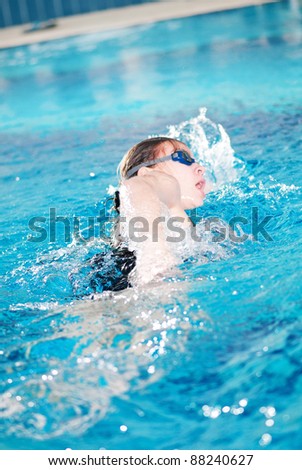 Swimming woman in blue pool