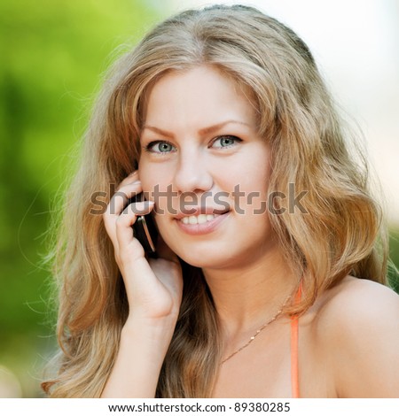 Young happy woman with mobile phone. SMS