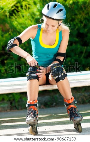 happy young woman on roller skates in the park