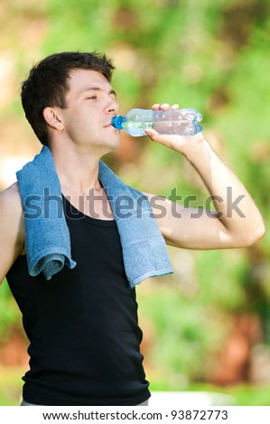Man drinking water after fitness exercise