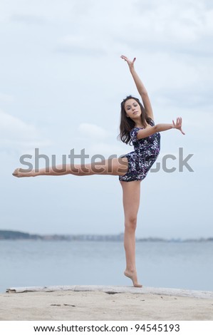young professional gymnast woman dance - outdoor sand beach