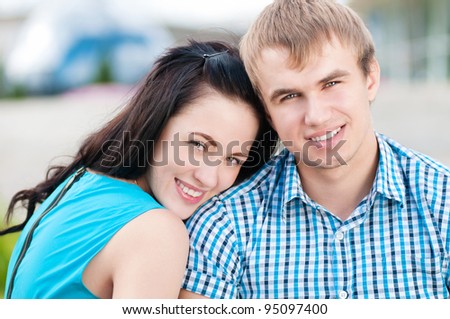 Portrait of a beautiful young happy smiling couple - green park outdoor