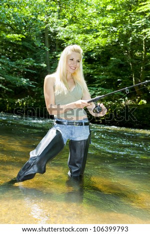woman fishing in river