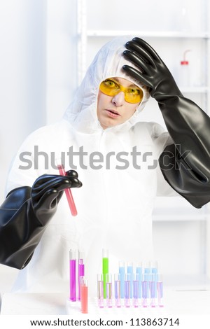 young woman wearing protective coat in laboratory