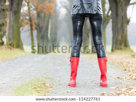 detail of woman wearing red rubber boots
