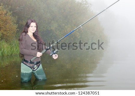 woman fishing in pond