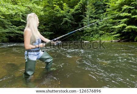 woman fishing in river