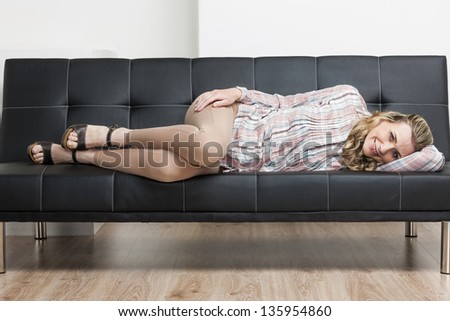 woman wearing summer shoes lying on sofa
