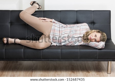 woman wearing summer shoes lying on sofa