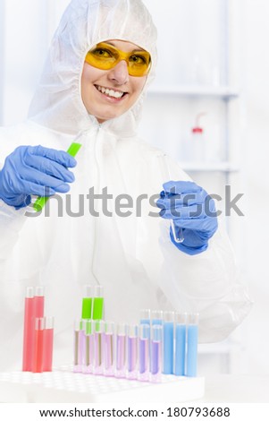 young woman wearing protective coat in laboratory