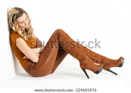 sitting woman wearing brown clothes and boots