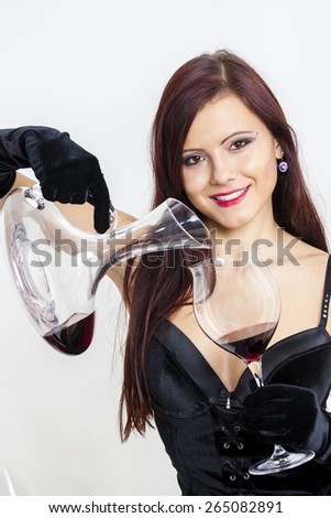 portrait of young woman with a glass of red wine and carafe